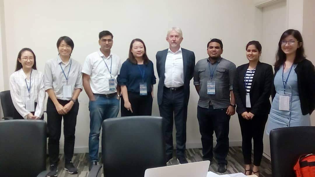 Programme participants standing with a FICPI course tutor after a tutorial session.